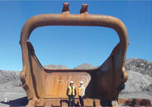 Marileze van Zyl and Karen Hooper in front of a dragline bucket.