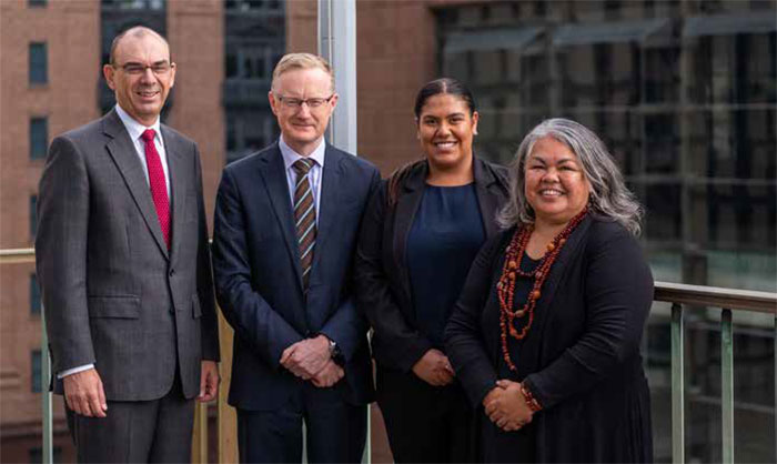 Wayne Byres (Payments System Board member and APRA Chairman), Governor Philip Lowe, Shakeela Williams and Susan Moylan-Coombs at the flag raising ceremony, May 2018