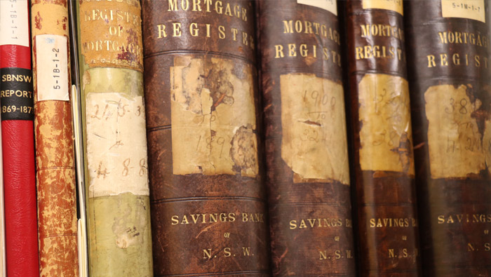 The spines of some old books on a shelf.